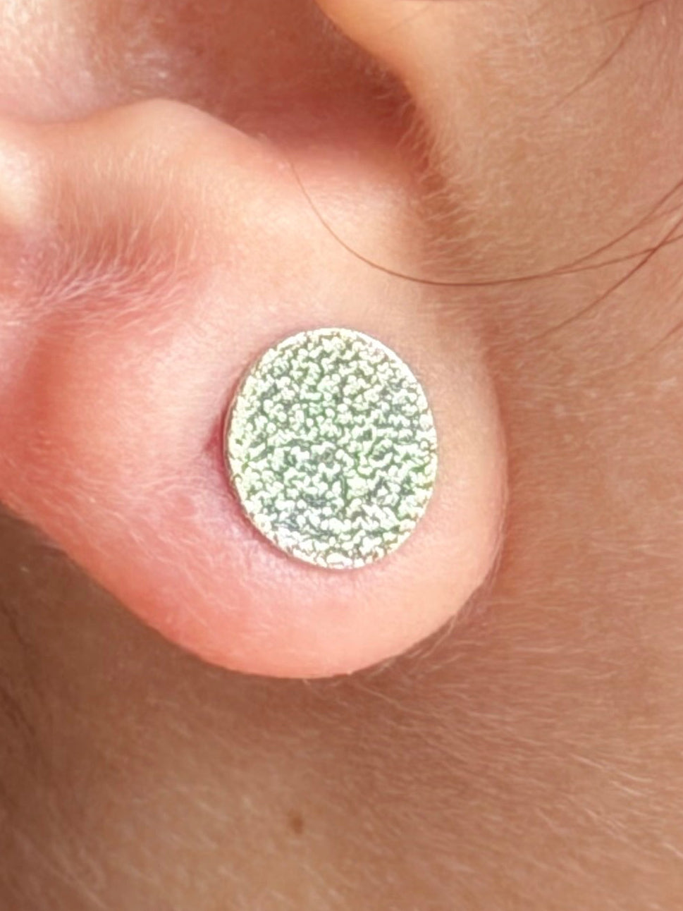 Close up of pebble shaped stud oxidised finish