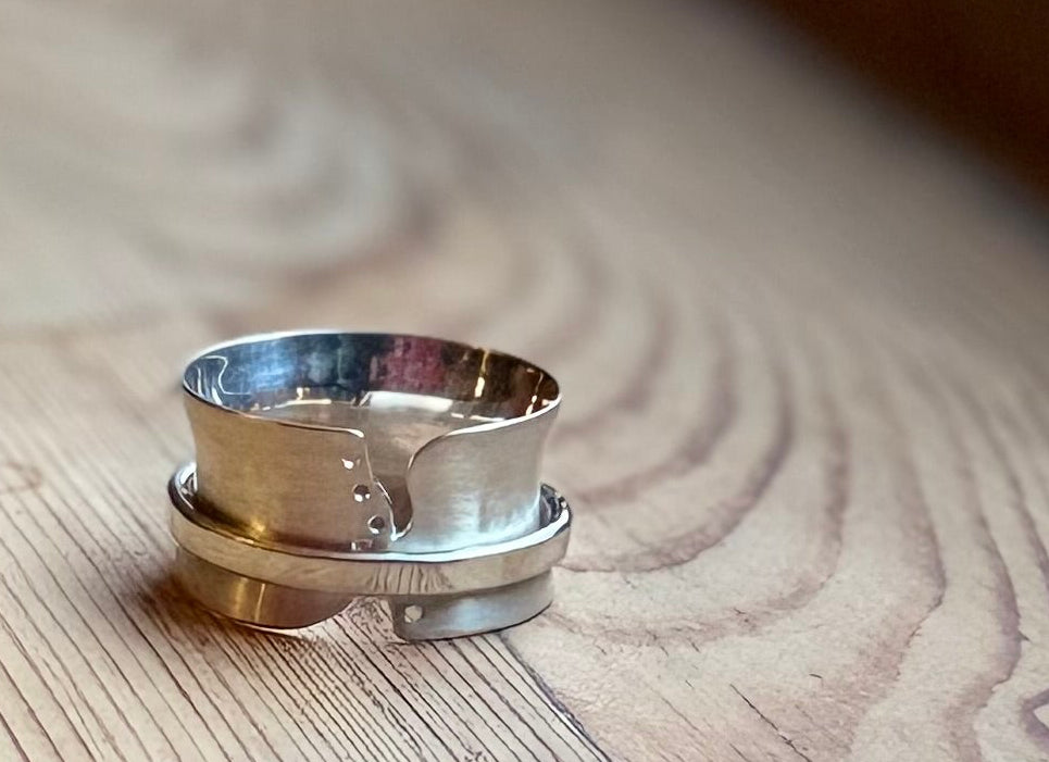 Silver spinner ring with cut outs and holes