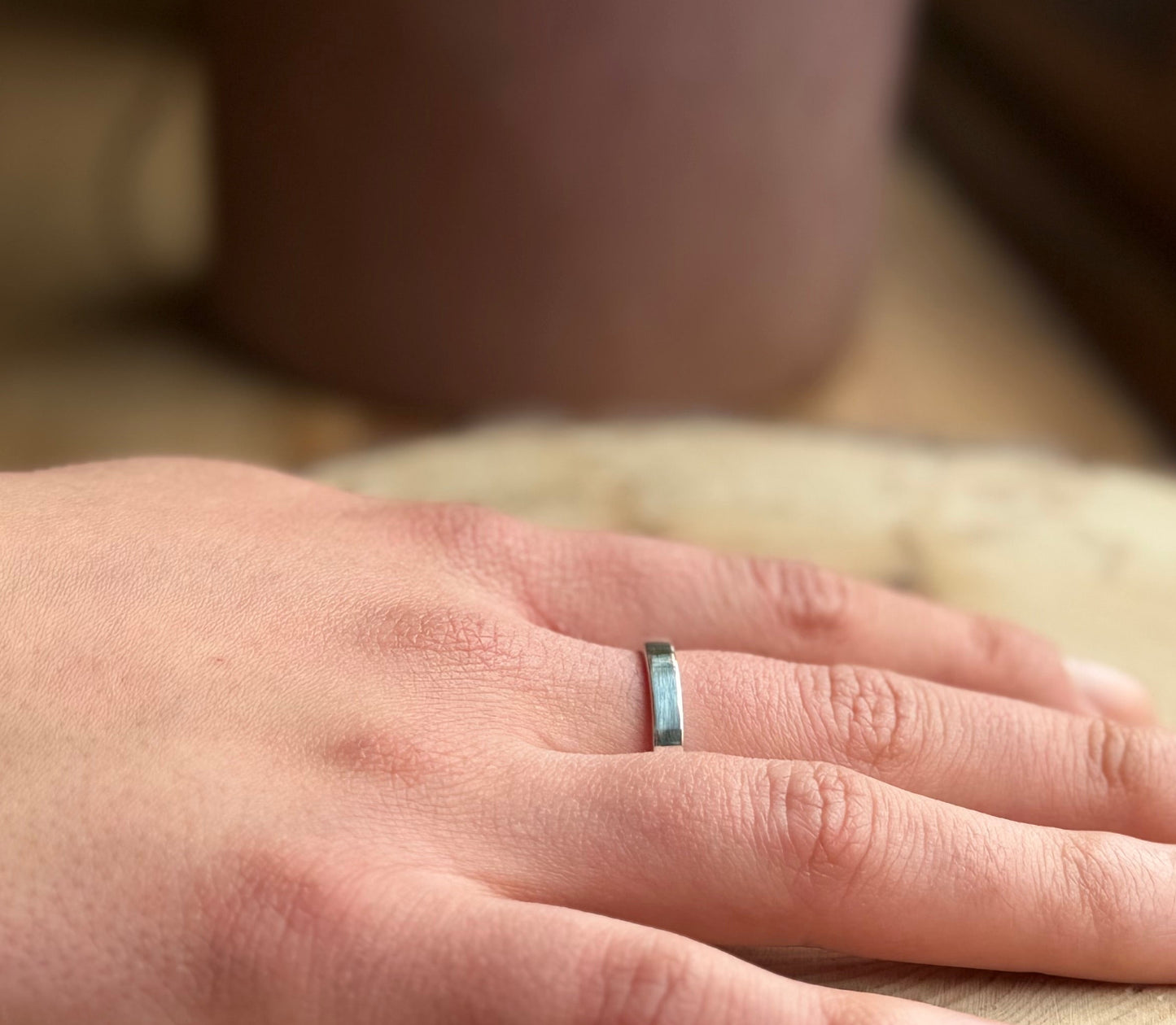 Silver flat ring on hand
