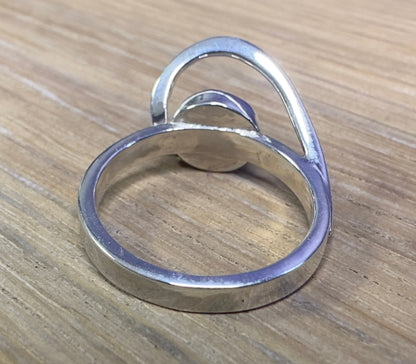 Silver ring on a wooden surface
