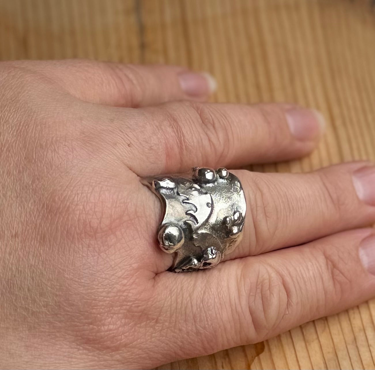 Alchemy Silver Thick molten band with beads and raised sections top view on hand