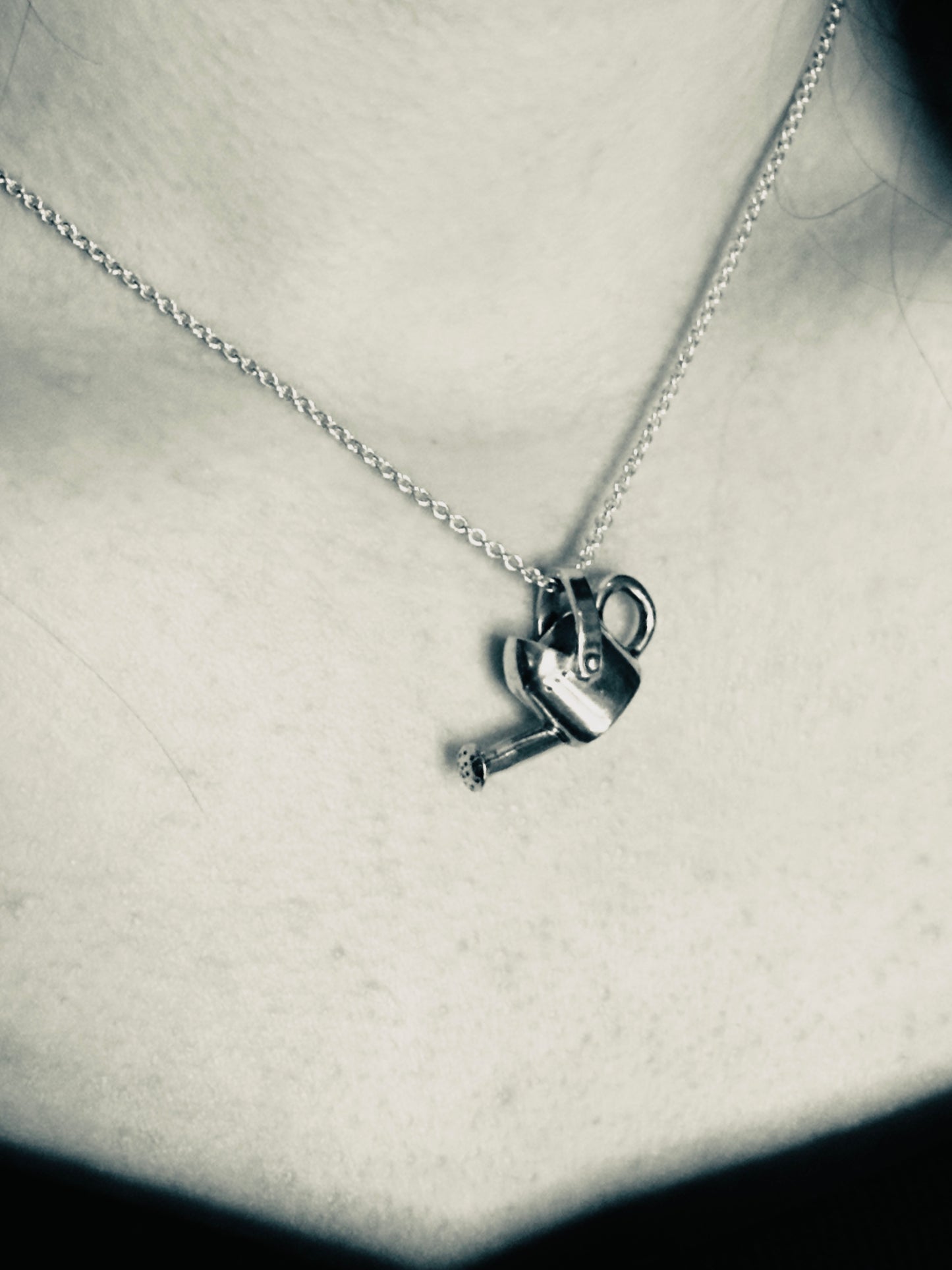 Silver necklace with a unique pendant on a neutral background