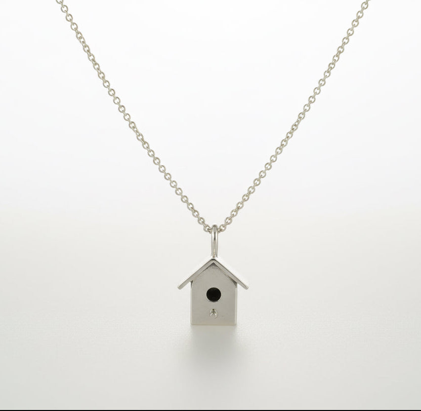 Necklace with a birdhouse pendant on a silver belcher chain