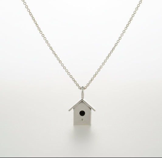Necklace with a birdhouse pendant on a silver belcher chain