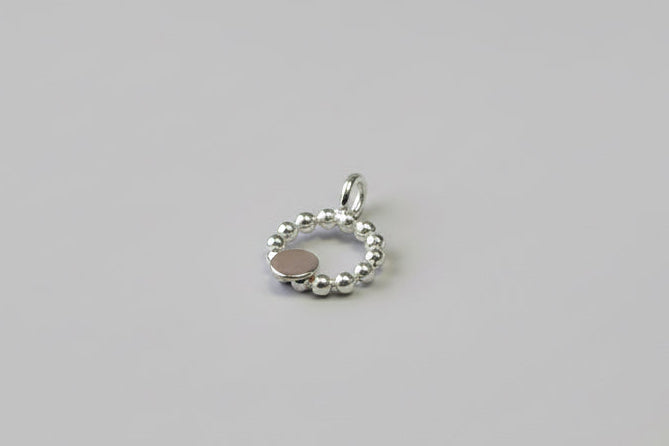 Beaded circle pendant with small textured 9ct yellow gold disc