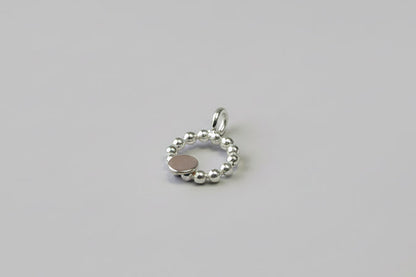Beaded circle pendant with small textured 9ct yellow gold disc