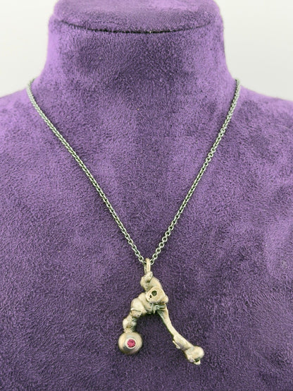 Necklace with a unique pendant on a purple mannequin