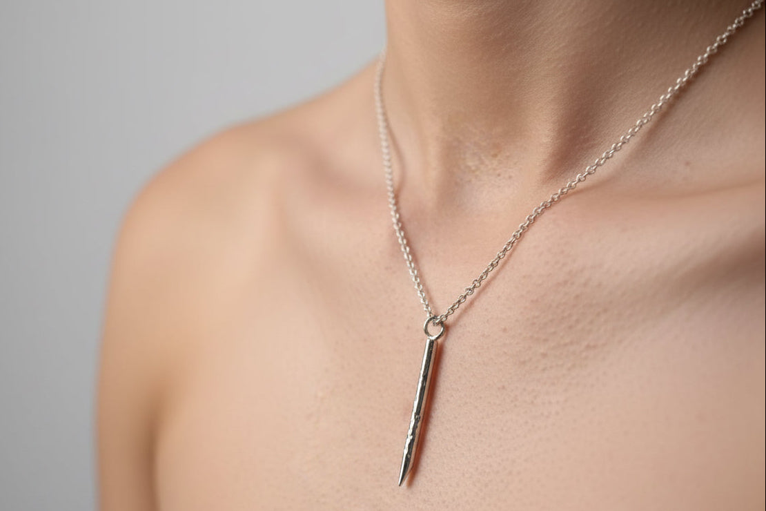 Studio with model wearing hammered rod pendant