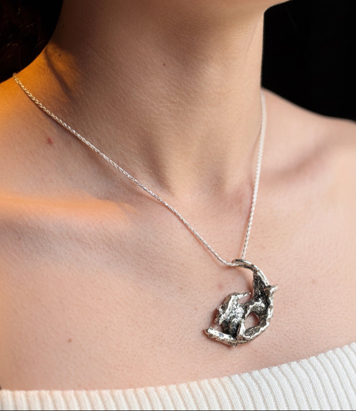 Hate on moon pendant on model
