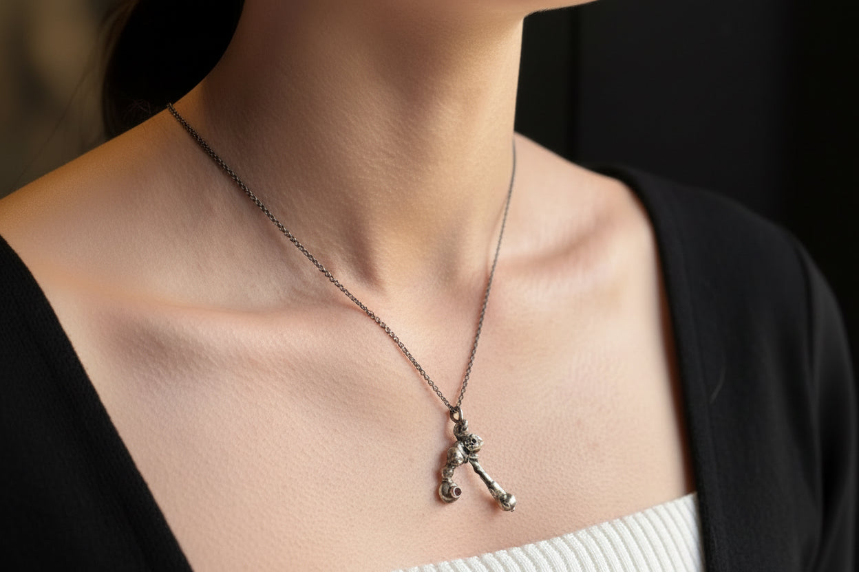 Silver Molten alchemy necklace with rhodolite garnet on model