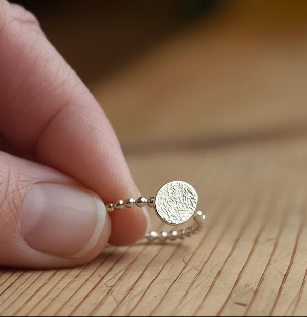 Silver beaded band with gold textured disc