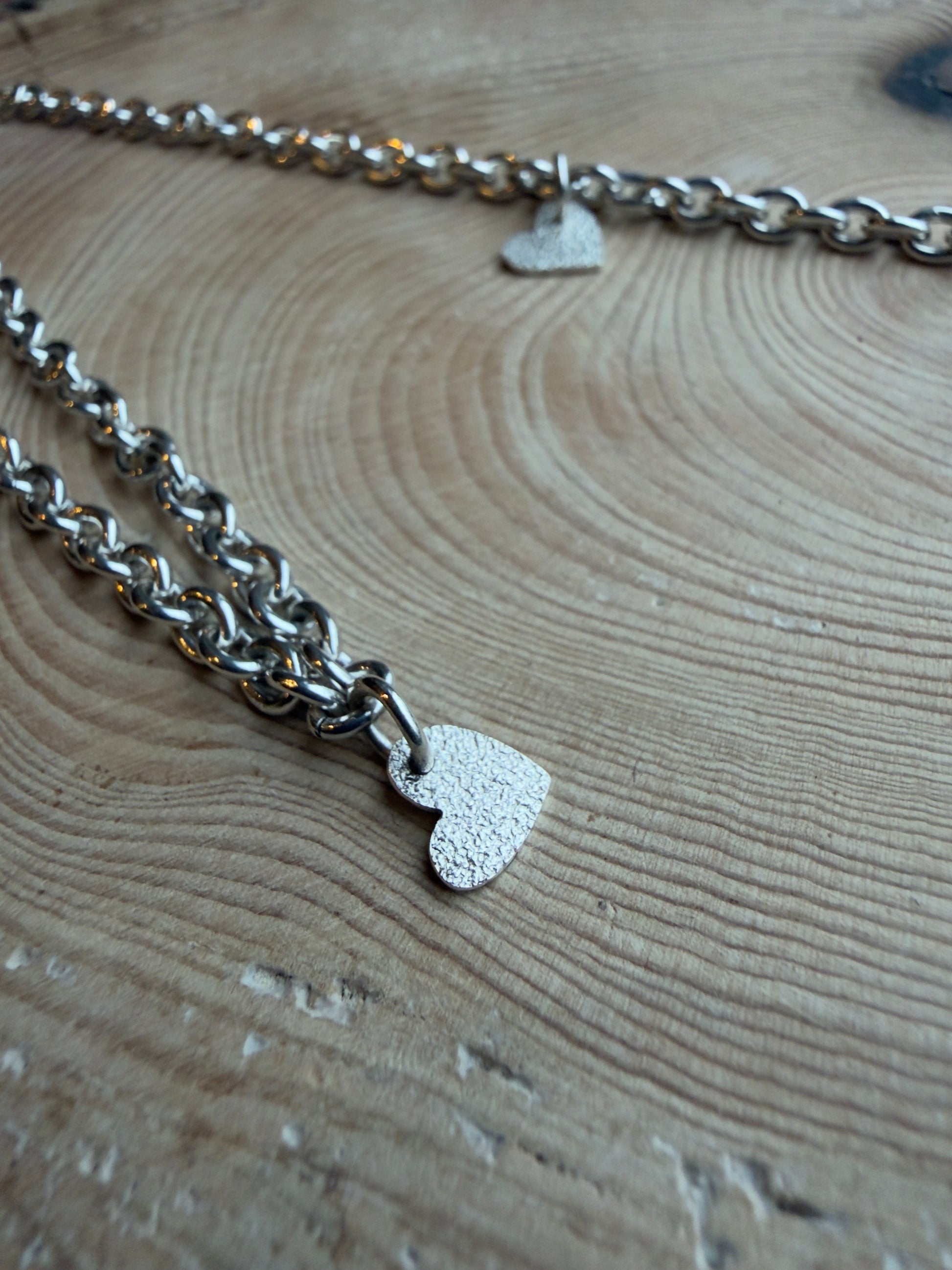 Silver frosted heart charm on bracelet