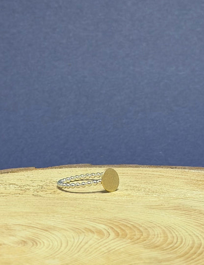 Close-up of a ring on a  tree stump with visible annual rings against a blue background