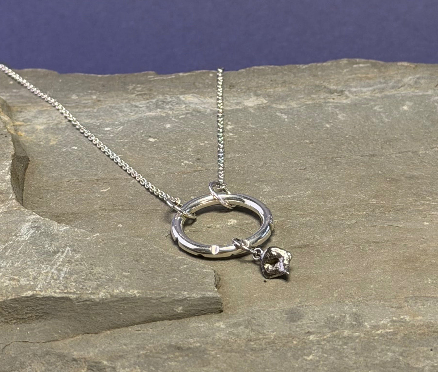 Silver molten drop ring necklace with carved recesses on the ring