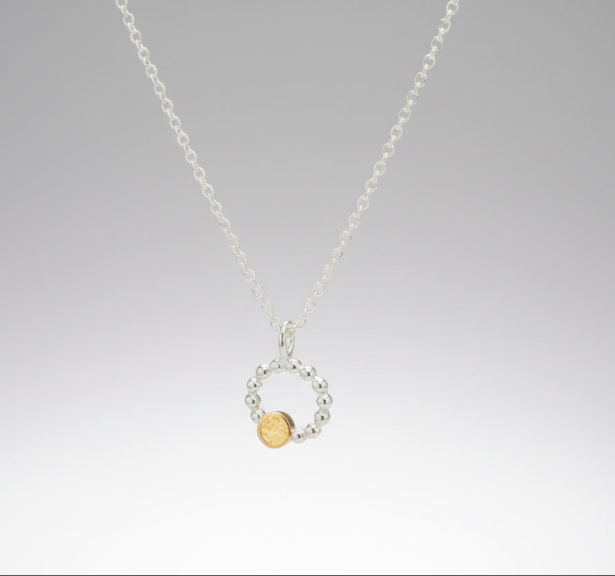 Beaded circle pendant with small textured 9ct yellow gold disc
