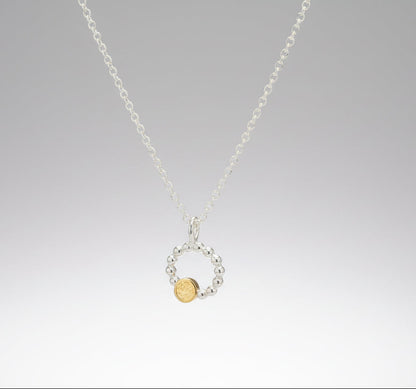 Beaded circle pendant with small textured 9ct yellow gold disc