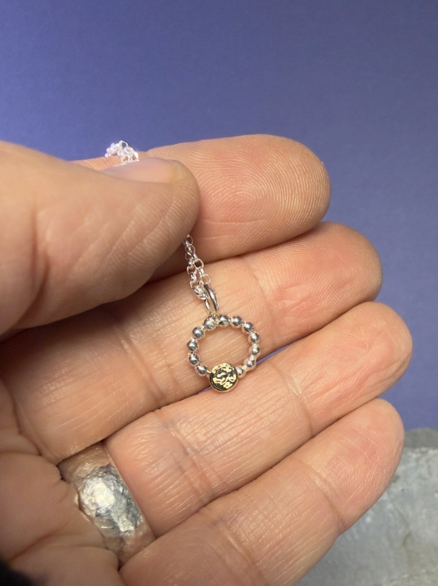 Beaded circle pendant with small textured 9ct yellow gold disc