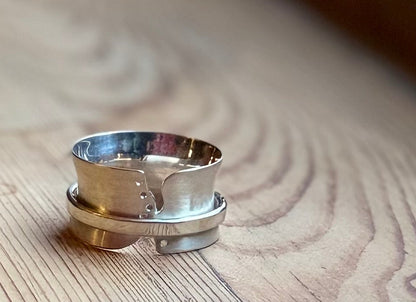 Silver spinner ring with cut outs and holes