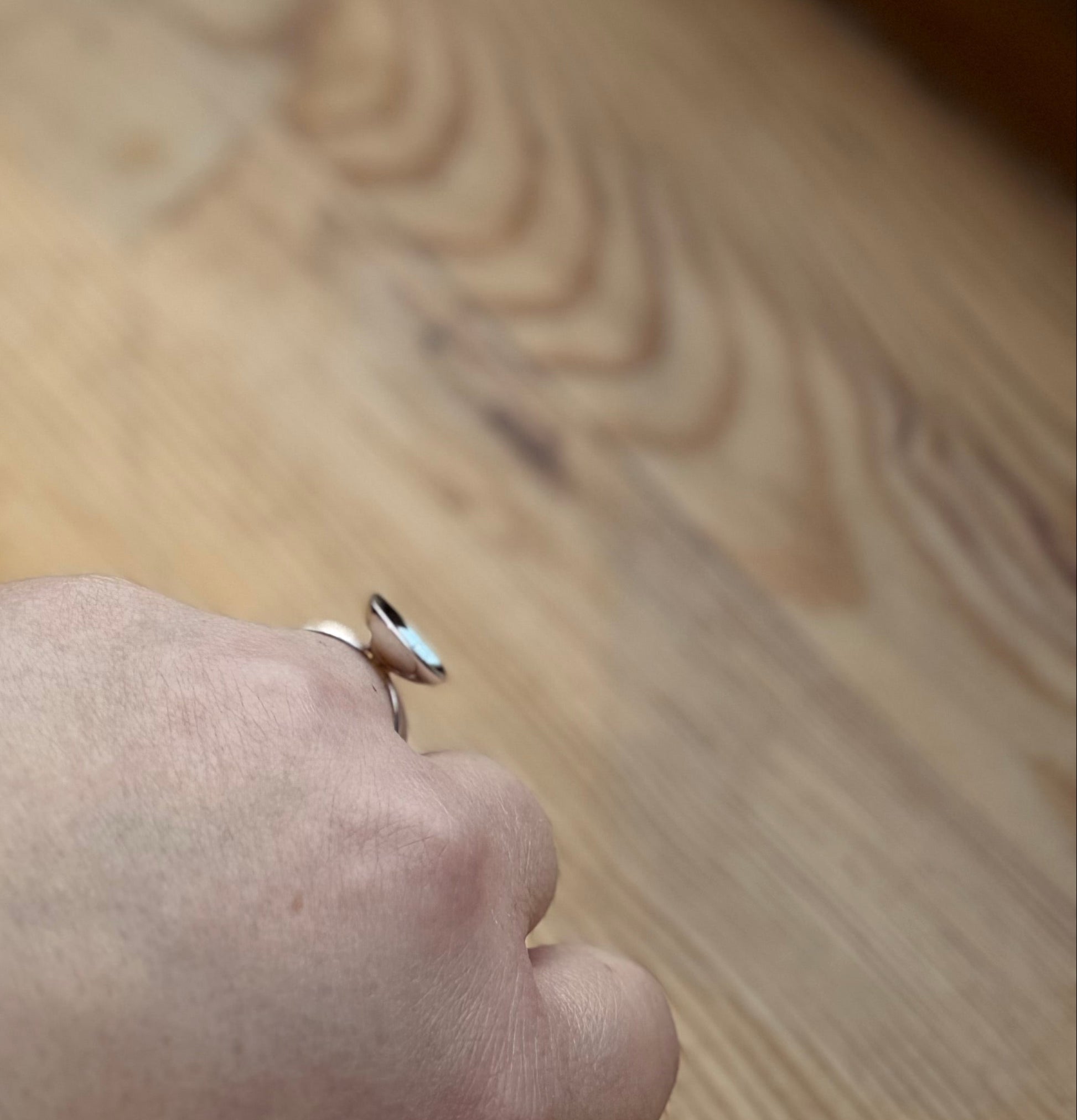 Silver ring with domed disc on hand