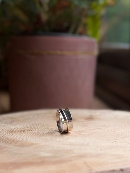 Hammered spinner ring on wooden base
