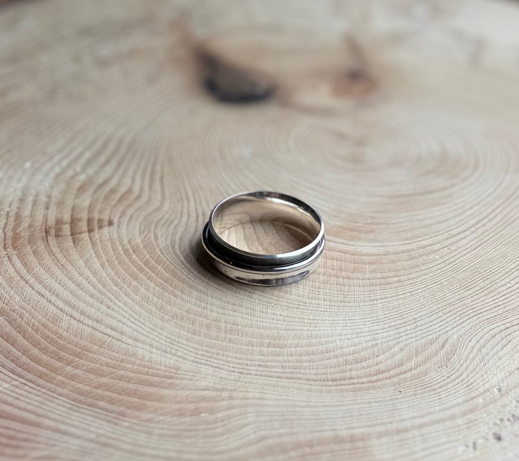 Oxidised Silver spinner ring on wood
