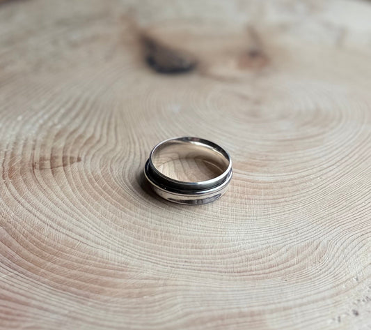 Oxidised Silver spinner ring on wood

