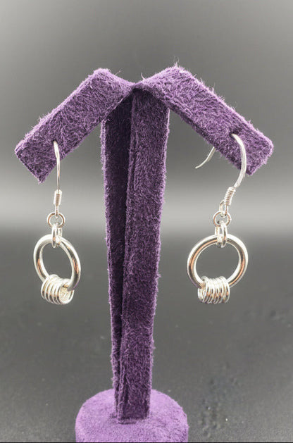 Silver drop earrings with a hoop and 5 fidget rings around them
