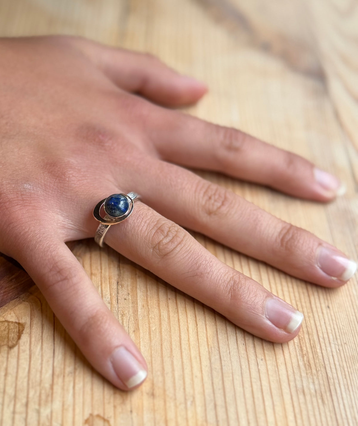 My World Is Rosy silver and 9 carat gold ring on hand