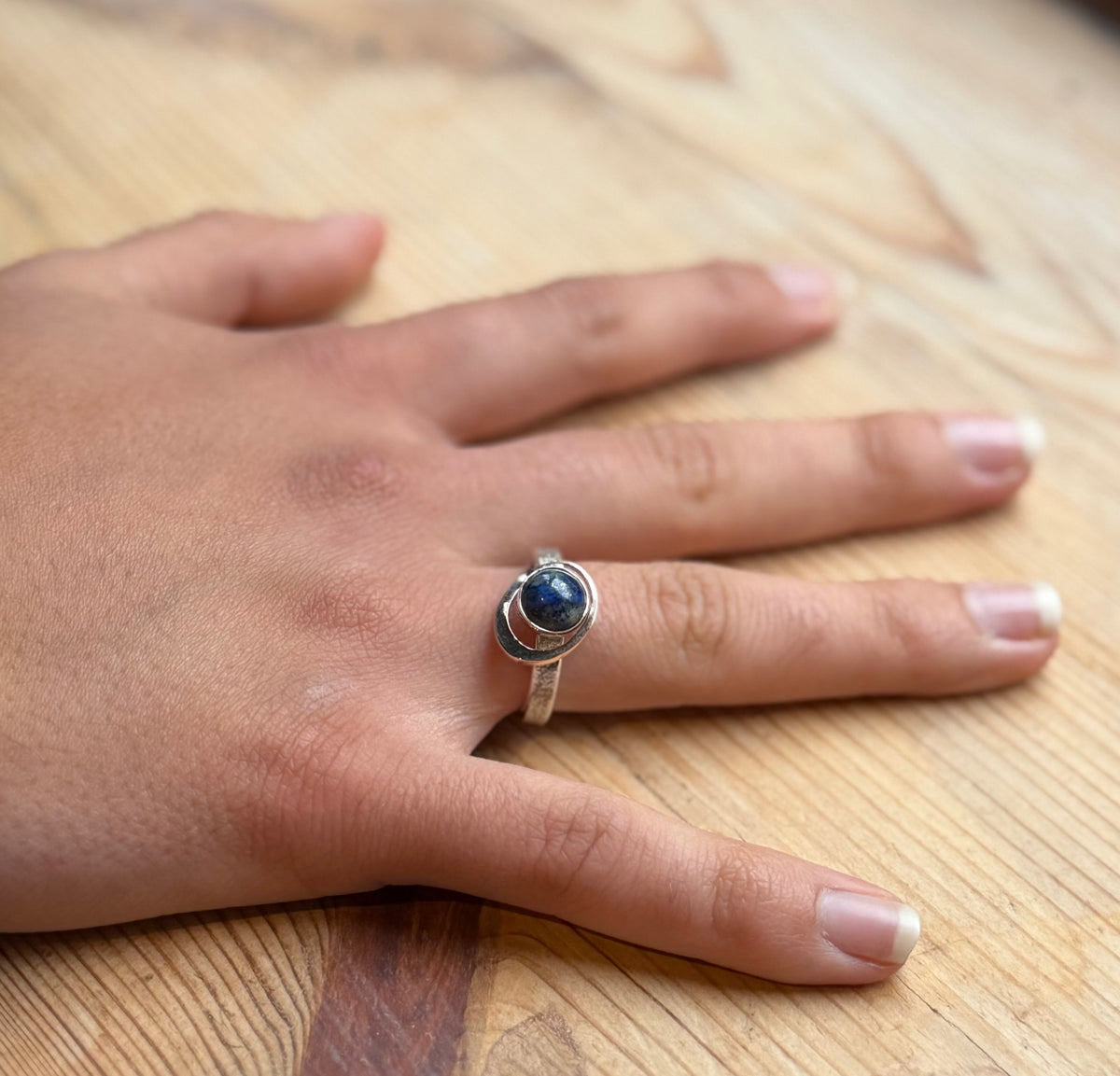 My World Is Rosy silver and 9 carat gold ring on hand
