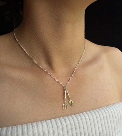 Silver miniature trowel and hand fork on belcher chain worn by model
