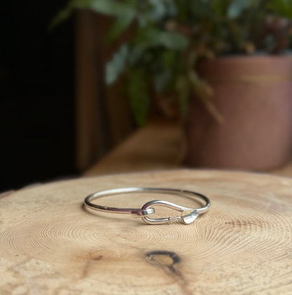 Bangle with trowel catch resting on wood