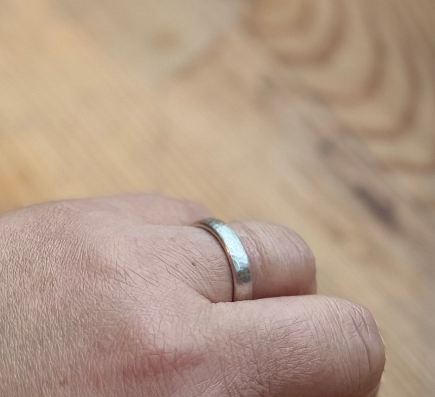 Court shaped comfort ring band. Hammered and satin finish
