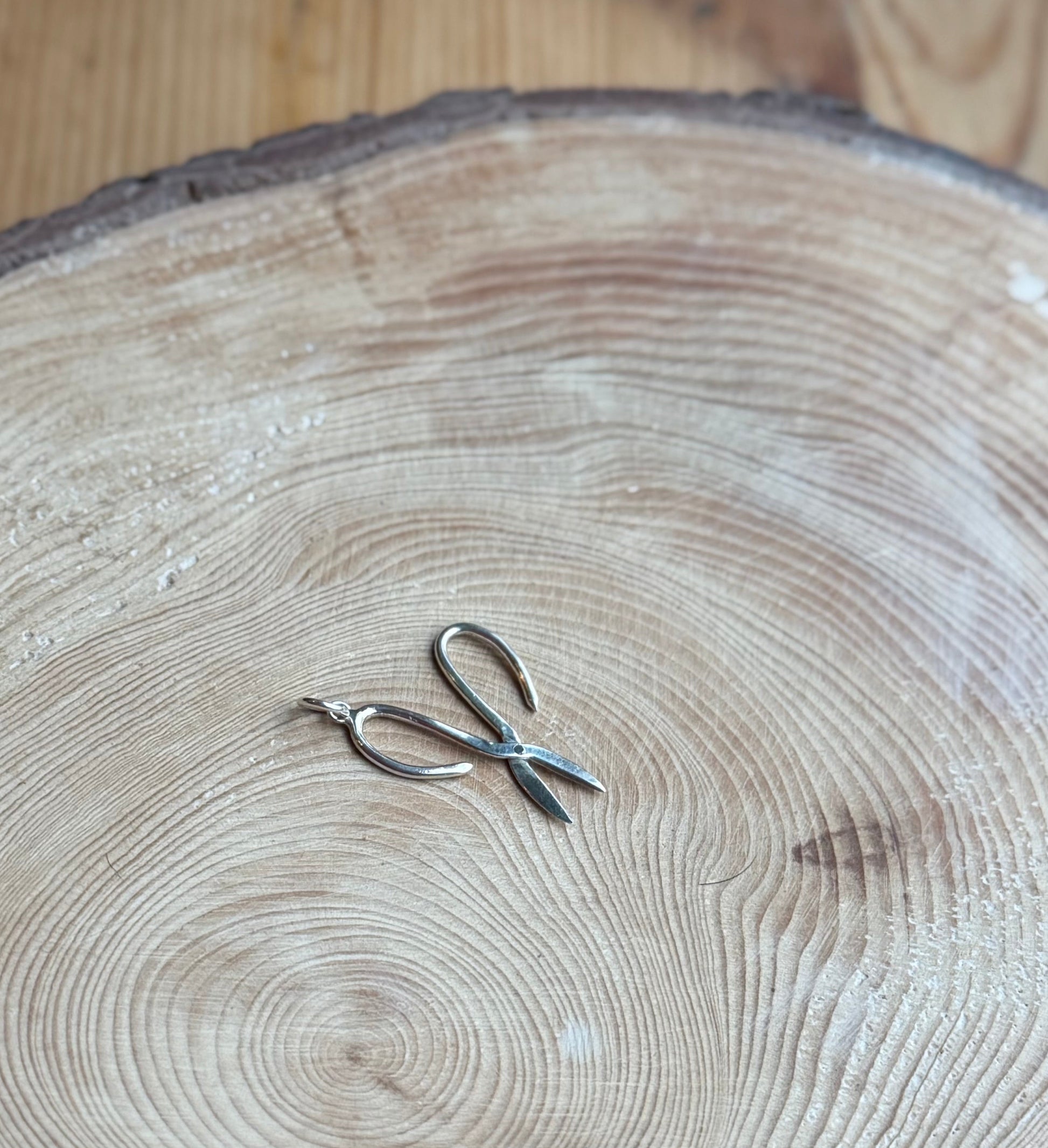 Garden scissors charm sat on wood