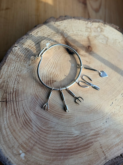 Silver Garden tool charms on bangle