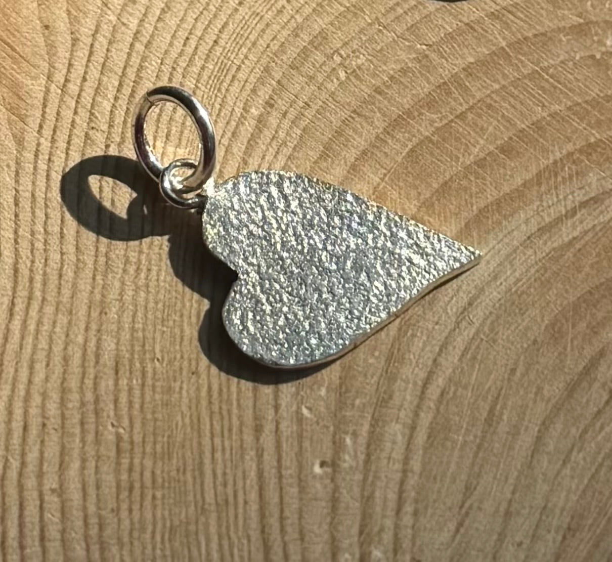 Frosted heart charm on wood