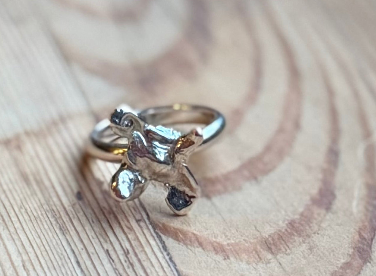 Molten silver ring from the alchemy range on wood
