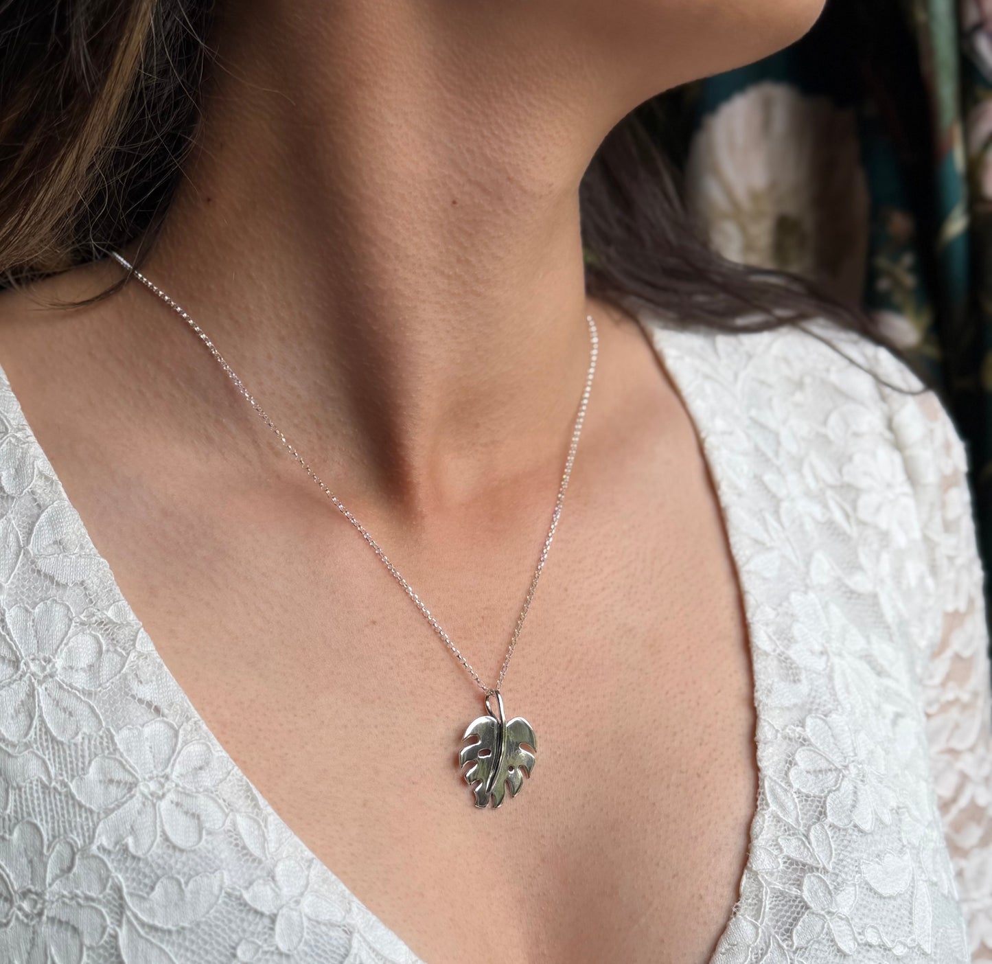 Monstera pendant on model in white lace top
