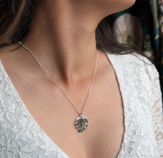 Monstera pendant on model in white lace top
