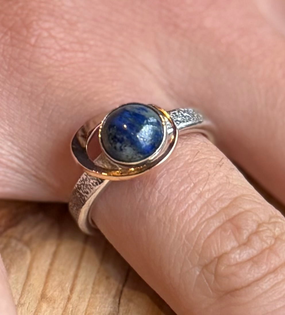 My World Is Rosy silver and 9 carat gold ring on hand