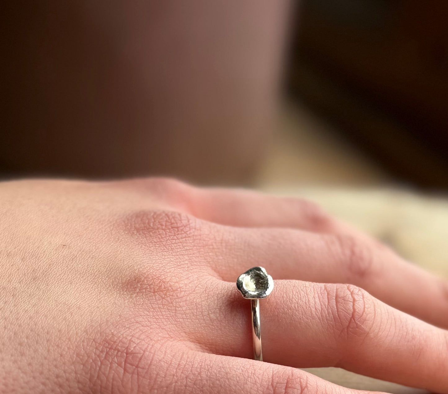 Silver molten ring from alchemy range on hand
