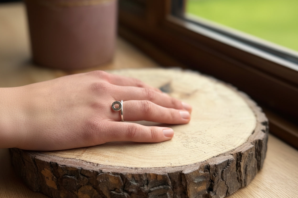 Silver ring band with donut shape on hand