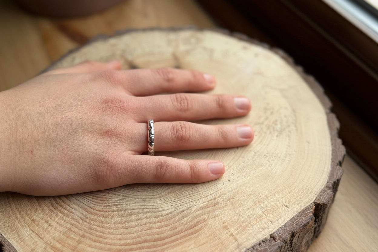 Silver round profile ring with filed shapes