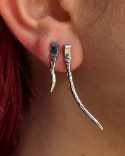 Two spike studs in model’s ear