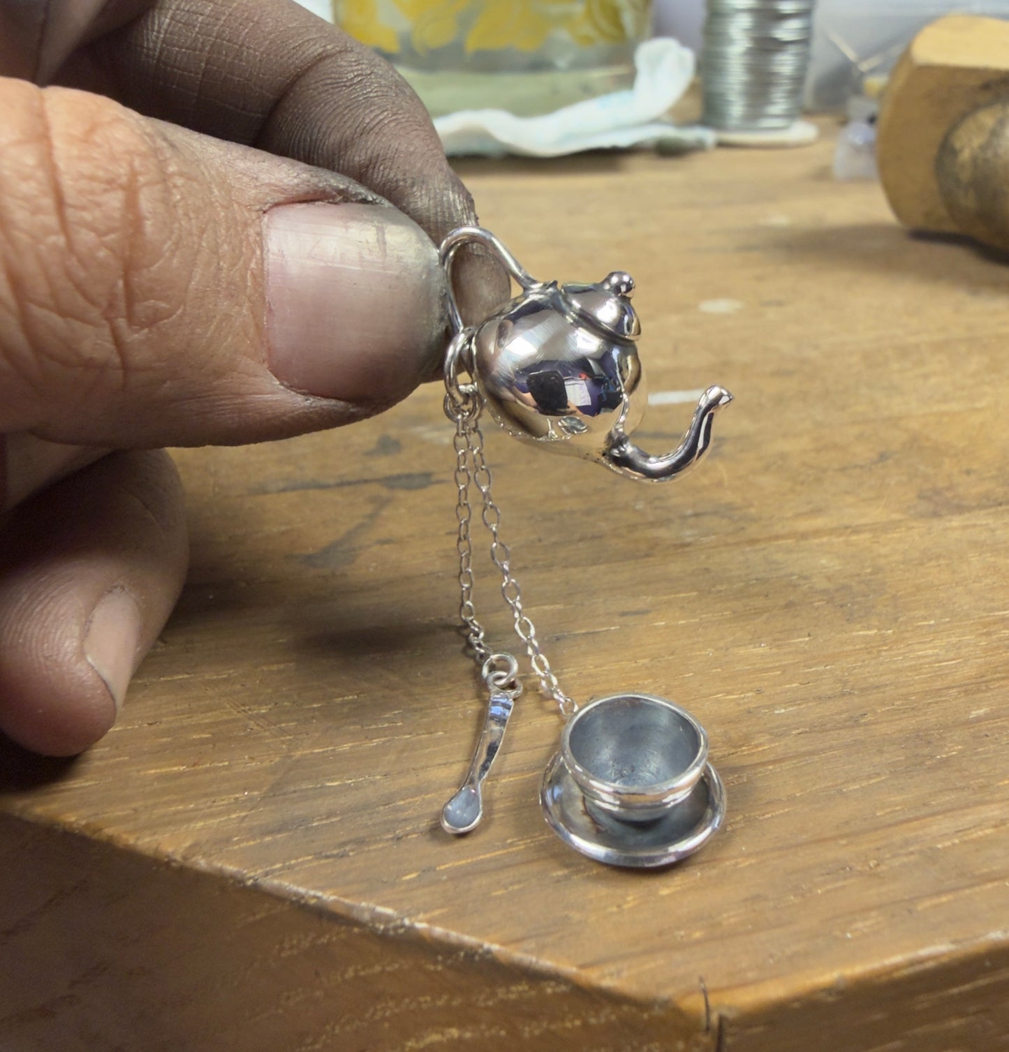 Teapot, teacup and soon made in silver in my workshop being held by my dirty hand!