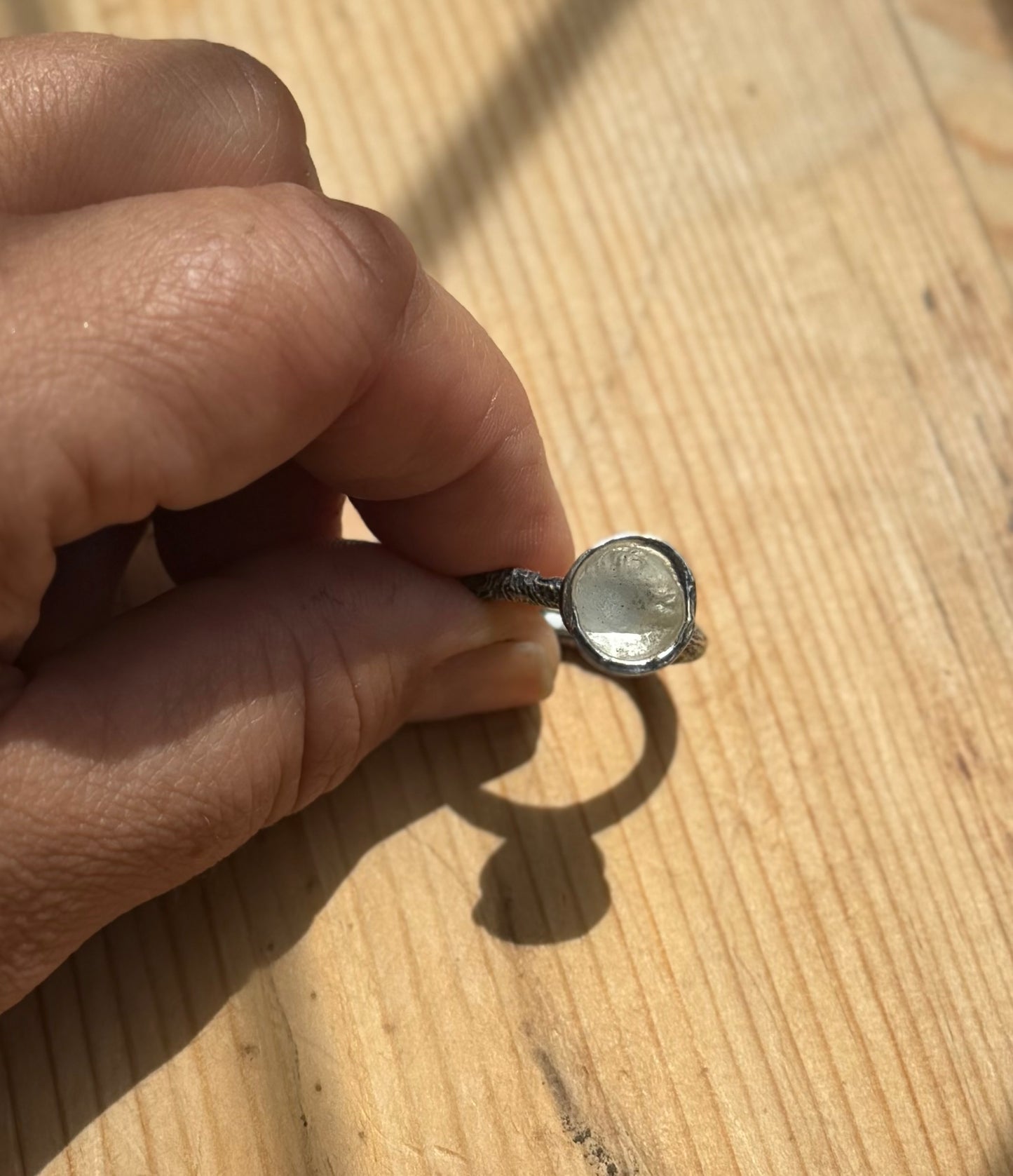 top view of a silver molten cup ring