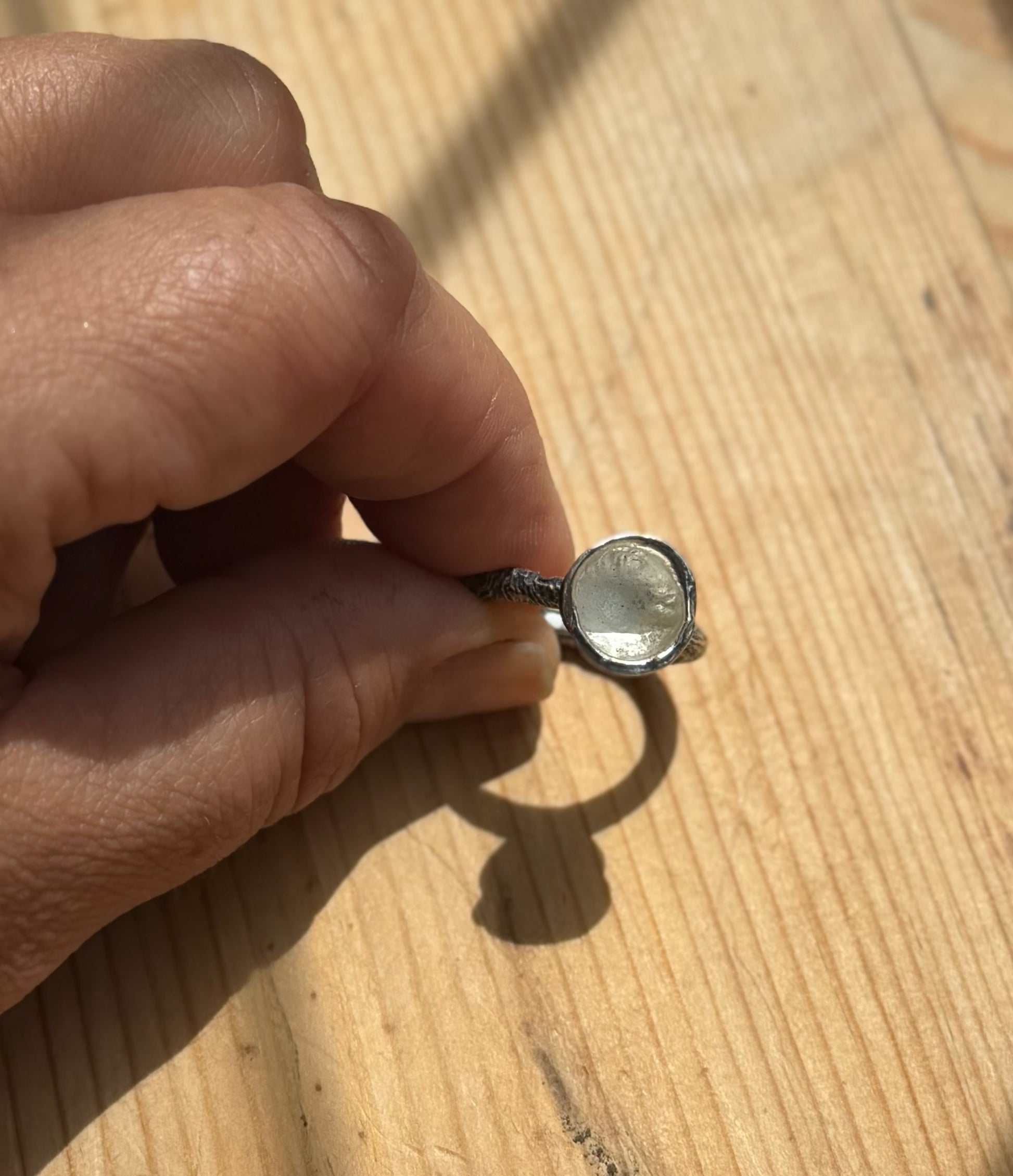top view of a silver molten cup ring