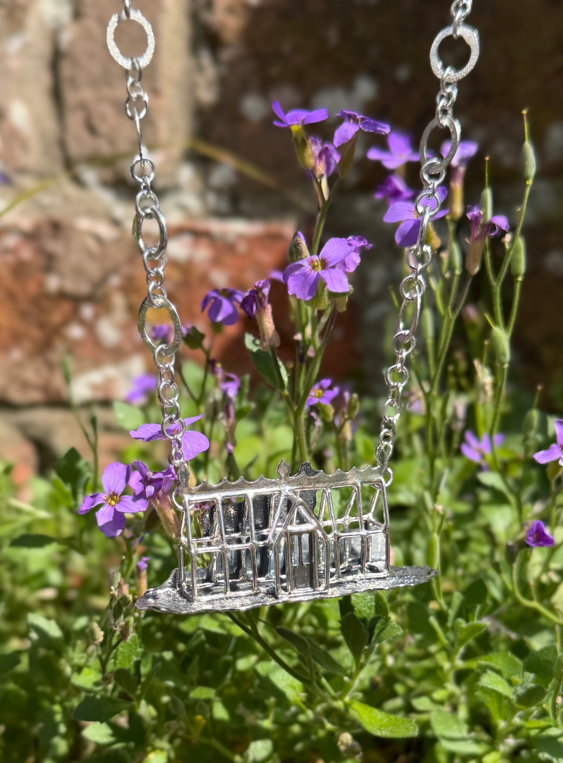Victorian greenhouse necklace with plants in background