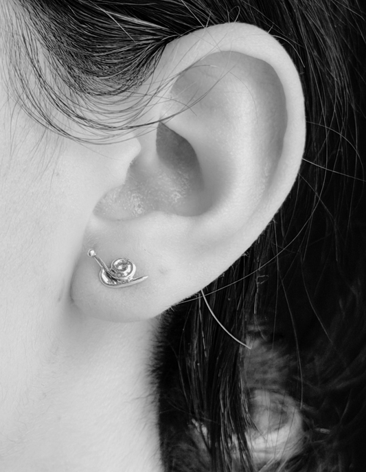 snail studs on ear in black and white